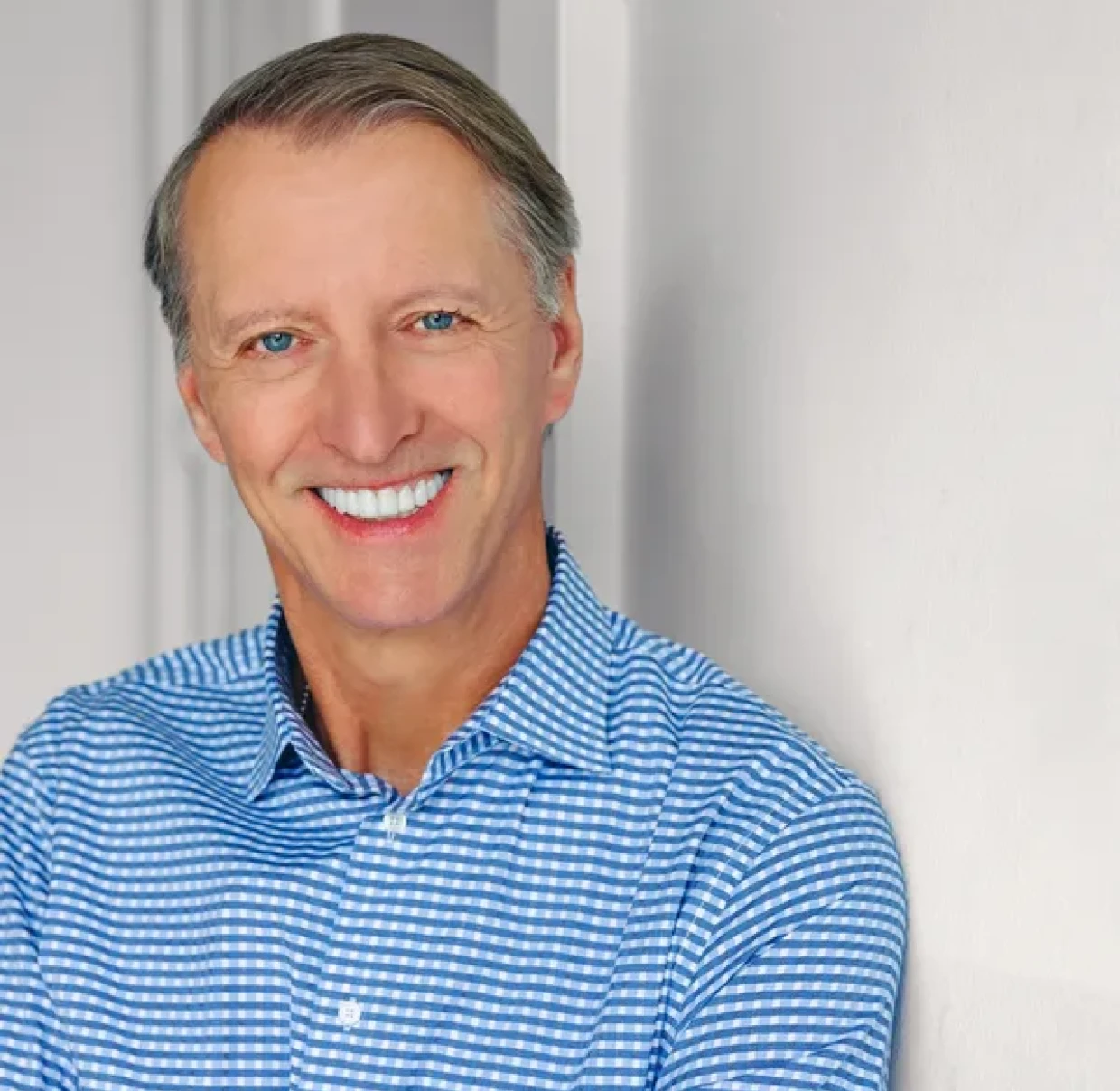 Happy person leaning against a wall